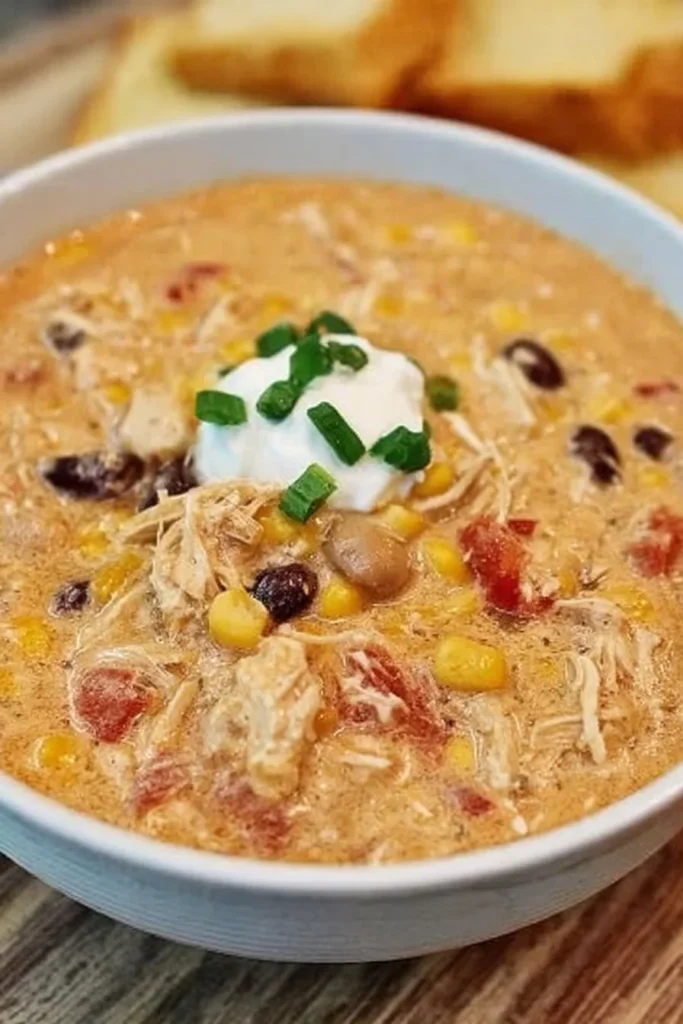 Cream Cheese Chicken Chili in a slow cooker, ready for serving and enjoying