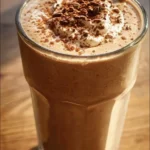 A nutritious coffee breakfast smoothie topped with fresh fruits