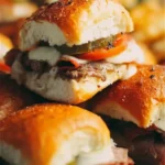 Plate of tasty Cuban Sliders with pickles and yellow mustard garnishing.