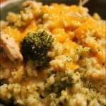 Easy Crockpot Cheesy Chicken Broccoli Rice recipe with creamy sauce and broccoli.