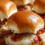 Delicious Kentucky Hot Brown Sliders topped with creamy sauce and crispy bacon
