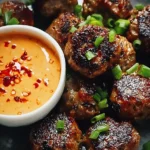 Korean BBQ Meatballs served with spicy mayo dip on a plate