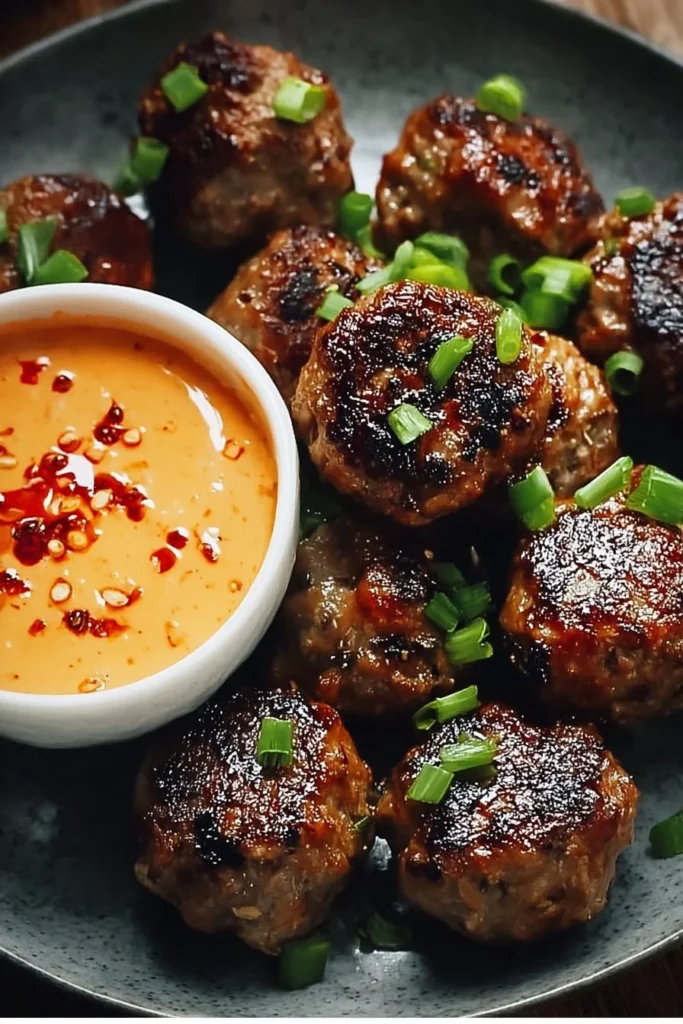 Korean BBQ Meatballs served with spicy mayo dip on a plate