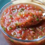 Picture of vibrant, fresh homemade salsa in a bowl with cilantro and tomatoes