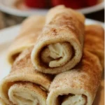 Delicious cinnamon sugar cheesecake roll-ups on a plate
