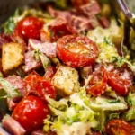 A vibrant bowl of Grinder Salad with fresh vegetables and herbs