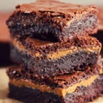 Delicious peanut butter stuffed brownies on a white plate